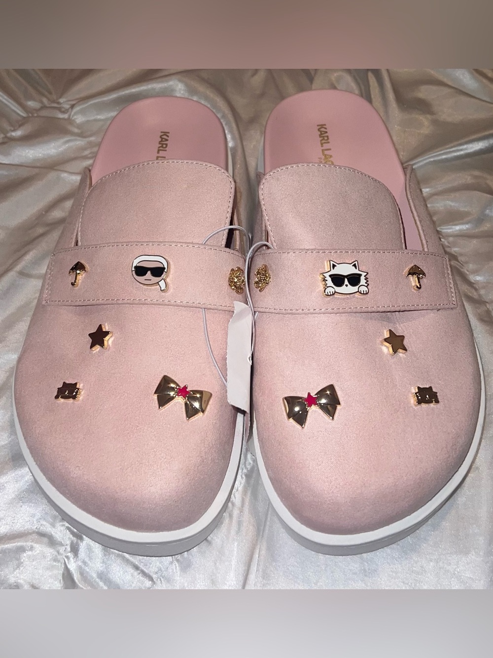 pink Karl Lagerfeld clogs featuring decorative charms